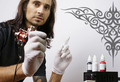 Tätowierer bei der Arbeit im Tattoostudio